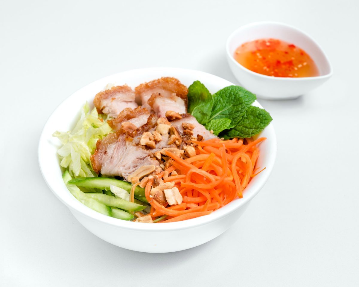 Vermicelli noodle bowl with roast pork, peanuts, mint and pickled carrot